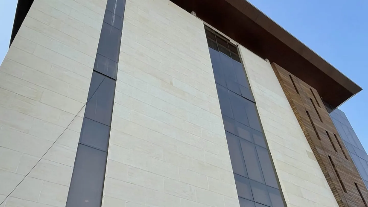 Sandstone-clad commercial facade, the destination end of a shipment once goods have cleared and been installed.