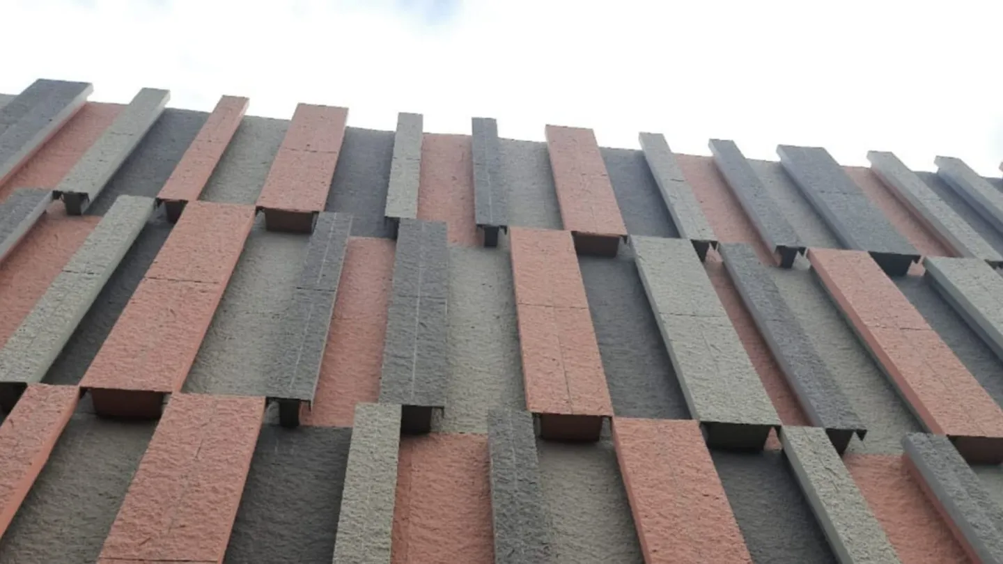Medical-centre facade of staggered textured panels, a specification-heavy build where substitution would be visible.