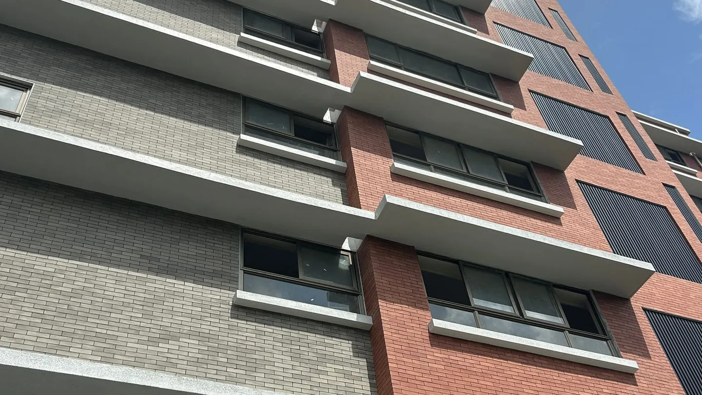 Multi-storey institutional building with mixed cladding, a finished project that could have been supplied by more than one role in the chain.